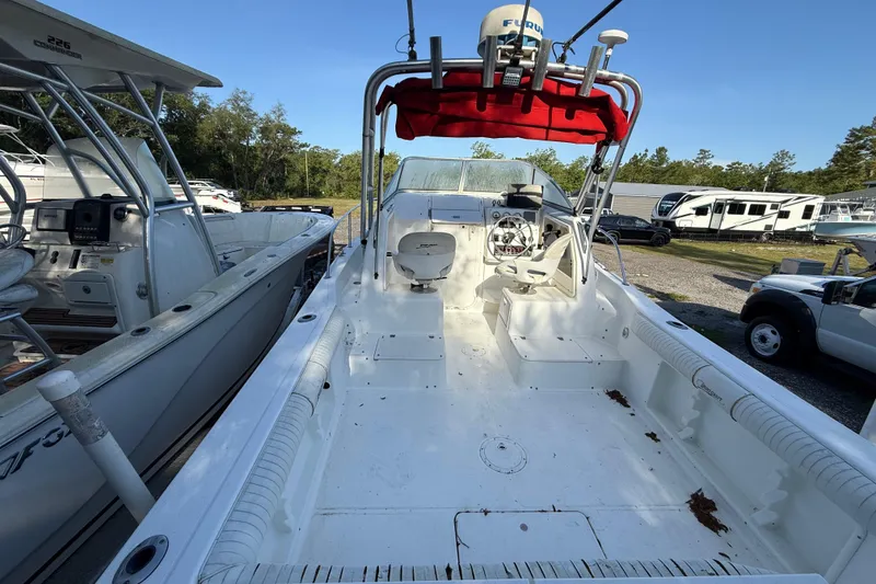 Slide: The Image of 2000 Sport-Craft 241 Walk Around boat with spacious deck and red canopy. - 43