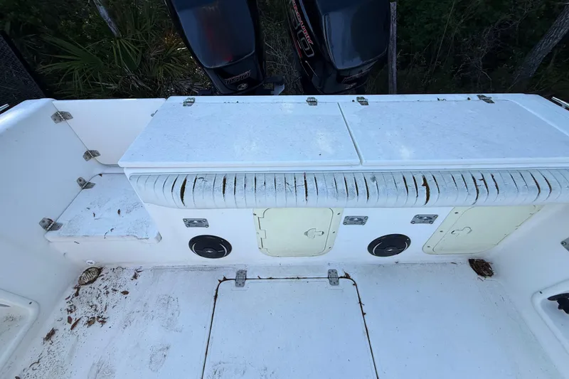 Slide: The Image of 2000 Sport-Craft 241 Walk Around boat interior with storage compartments and seating. - 47