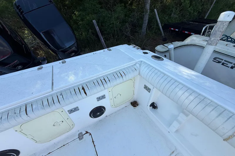 Slide: The Image of 2000 Sport-Craft 241 Walk Around boat deck with storage compartments and seating. - 48