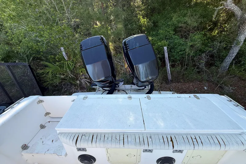 Slide: The Image of 2000 Sport-Craft 241 Walk Around boat with dual outboard motors in a wooded area. - 51