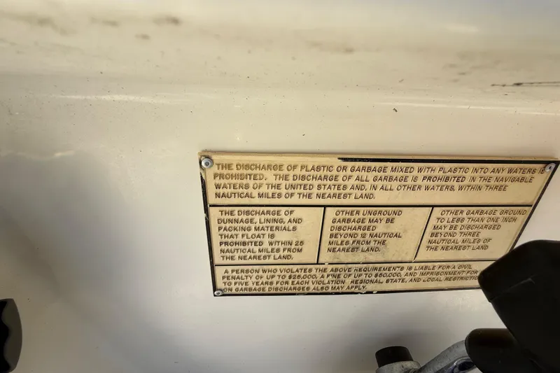 Slide: The Image of Warning plaque on 2000 Sport-Craft 241 Walk Around boat about garbage discharge regulations. - 61