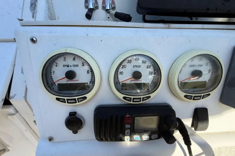 Slide: The Image of Dashboard of a 2000 Sport-Craft 241 Walk Around boat with gauges and controls. - 63