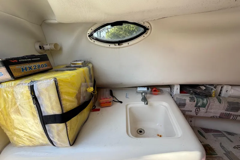 Slide: The Image of Interior of a 2000 Sport-Craft 241 Walk Around boat with sink and storage. - 64