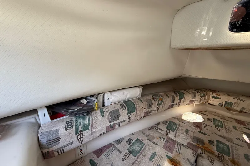 Slide: The Image of Interior cabin of a 2000 Sport-Craft 241 Walk Around boat with patterned seating. - 65