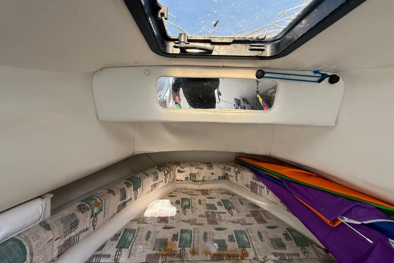 Slide: The Image of Interior cabin of 2000 Sport-Craft 241 Walk Around boat with patterned cushions. - 66