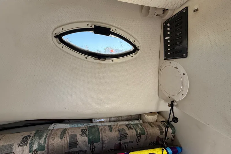 Slide: The Image of Interior of 2000 Sport-Craft 241 Walk Around boat with window and control panel. - 68