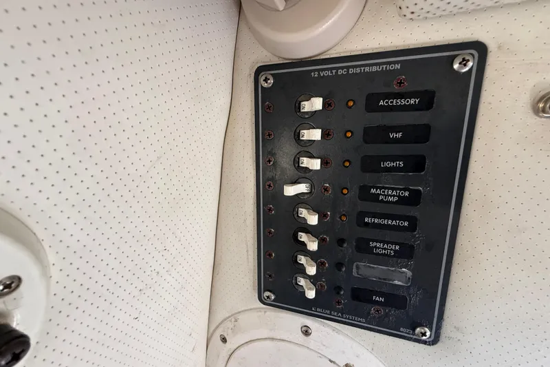 Slide: The Image of Control panel of a 2000 Sport-Craft 241 Walk Around boat with labeled switches. - 69