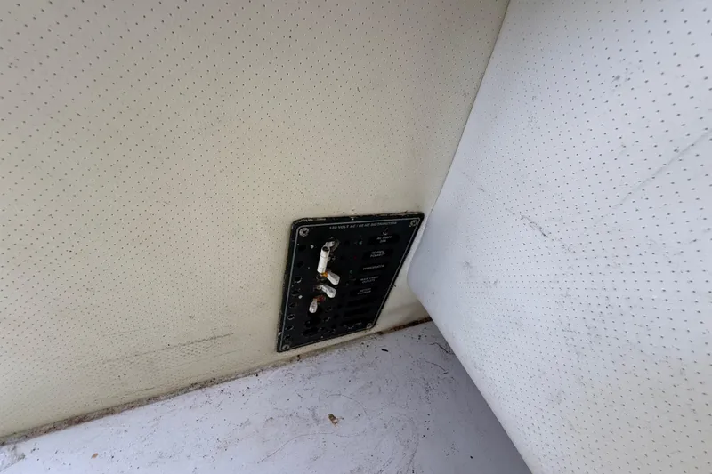 Slide: The Image of Electrical panel on a 2000 Sport-Craft 241 Walk Around boat interior. - 75