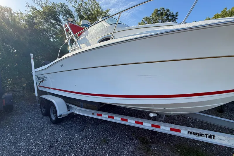 Slide: The Image of 2000 Sport-Craft 241 Walk Around boat on trailer, side view, outdoors. - 8