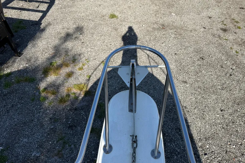 Slide: The Image of Bow view of 2000 Sport-Craft 241 Walk Around boat on gravel surface. - 83