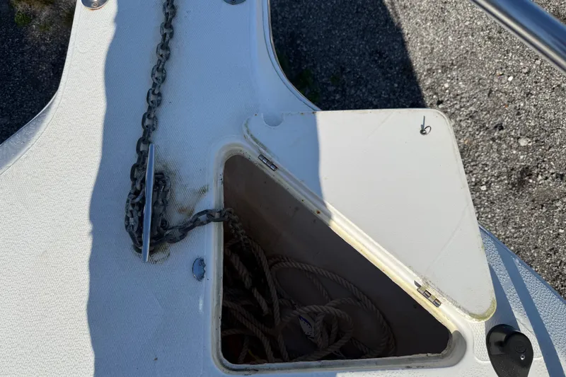 Slide: The Image of Anchor locker of a 2000 Sport-Craft 241 Walk Around boat with chain and rope. - 84