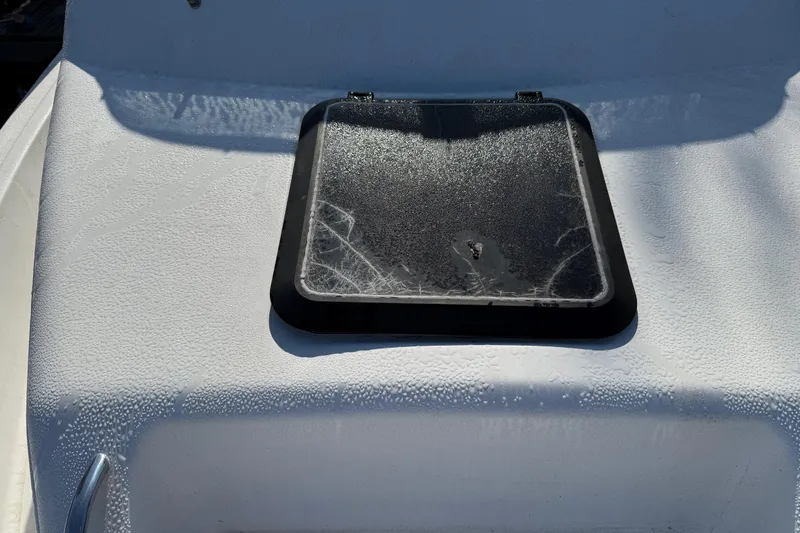 Slide: The Image of Hatch on 2000 Sport-Craft 241 Walk Around boat, covered in morning dew. - 85