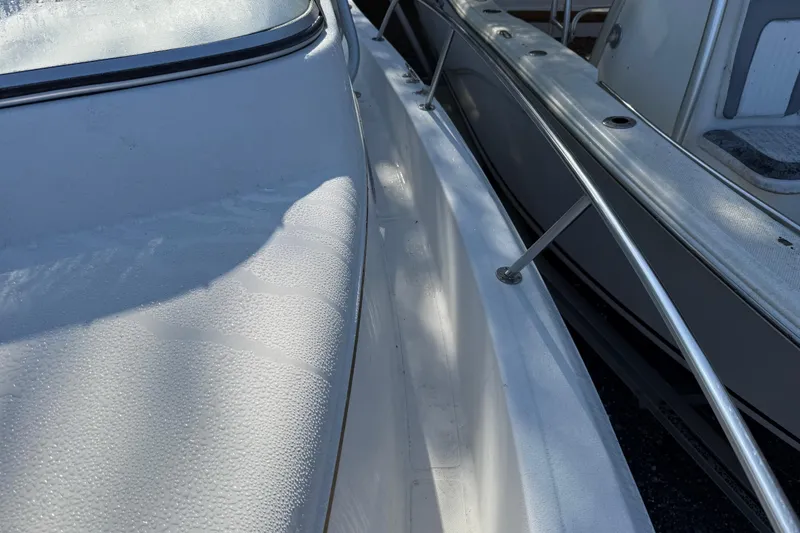 Slide: The Image of 2000 Sport-Craft 241 Walk Around boat deck with morning dew. - 88