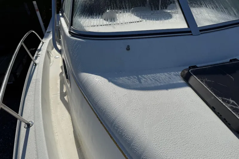 Slide: The Image of 2000 Sport-Craft 241 Walk Around boat with morning dew on deck and windshield. - 92