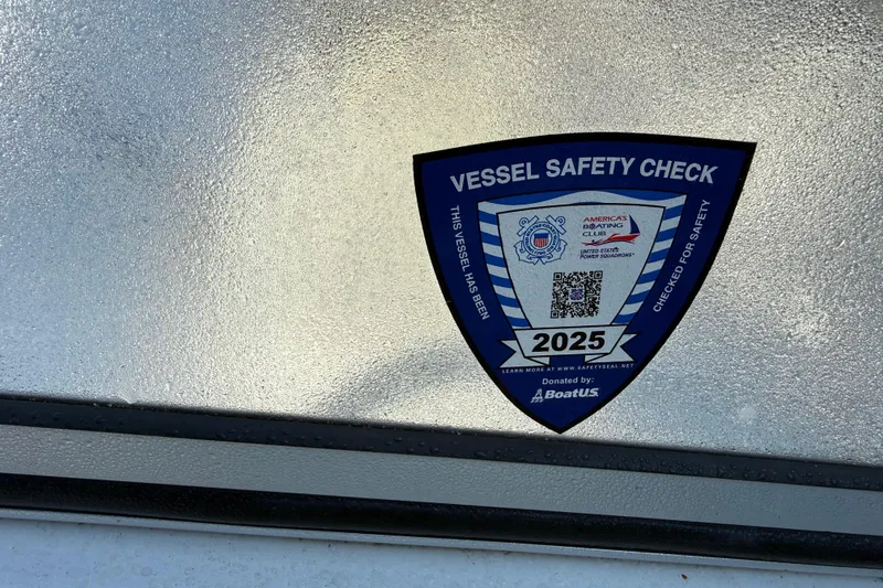 Slide: The Image of Vessel safety check sticker on 2000 Sport-Craft 241 Walk Around boat, valid until 2025. - 96