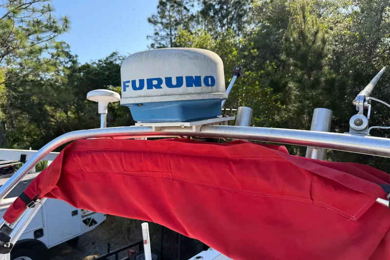 Slide: The Image of Radar equipment on a 2000 Sport-Craft 241 Walk Around boat with red canvas cover. - 97