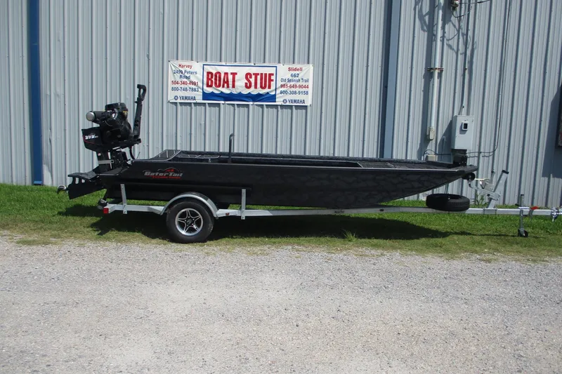The Image of 2026 Gator Tail 1854 Extreme boat on trailer, parked outside a metal building. - 0