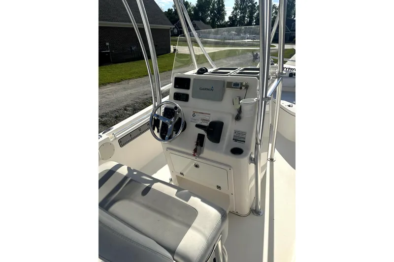 Slide: The Image of 2019 Cobia 220 Center Console boat interior with Garmin navigation system. - 2