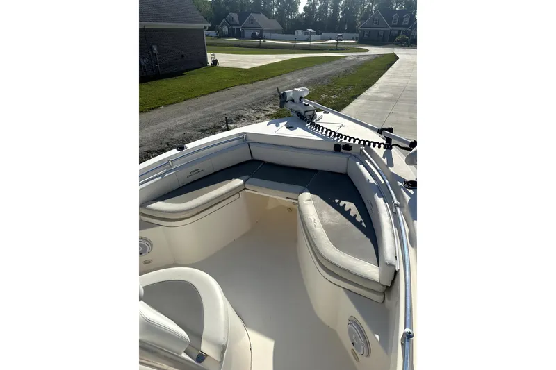 Slide: The Image of 2019 Cobia 220 Center Console boat with cushioned seating and trolling motor. - 3