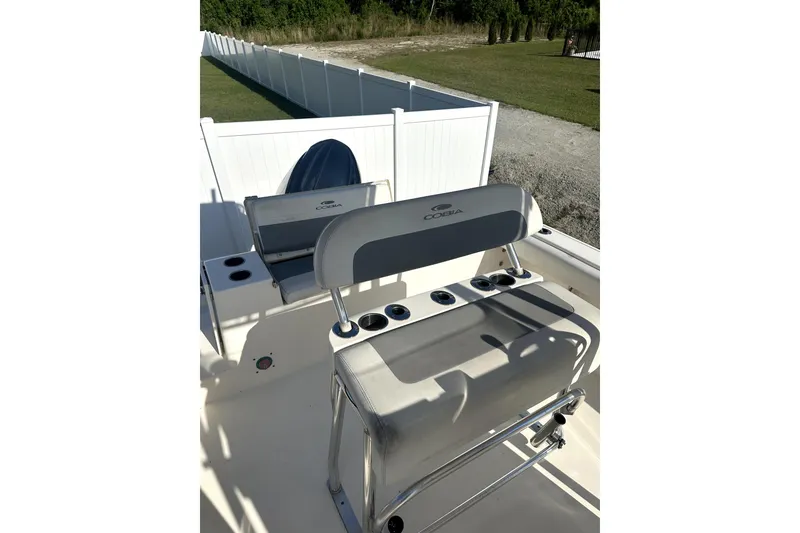 Slide: The Image of 2019 Cobia 220 Center Console boat interior with seating and rod holders. - 4