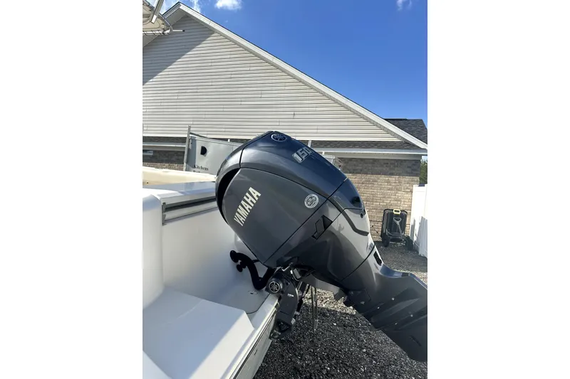 Slide: The Image of 2019 Cobia 220 Center Console with Yamaha outboard motor in driveway. - 5
