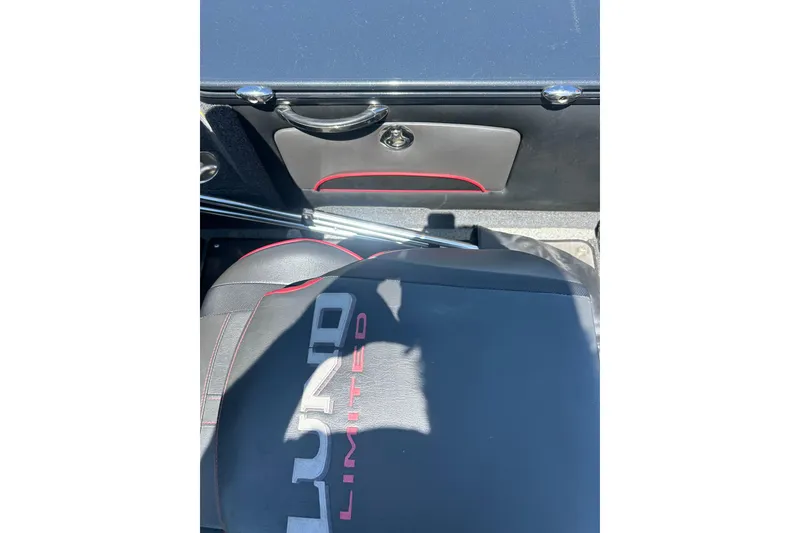 Slide: The Image of 2021 Lund 2075 Pro-V Limited boat interior with branded seat and storage compartment. - 13