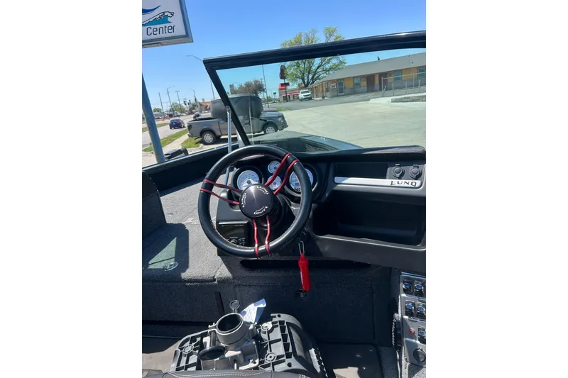 Slide: The Image of 2021 Lund 2075 Pro-V Limited boat dashboard with steering wheel and controls. - 17