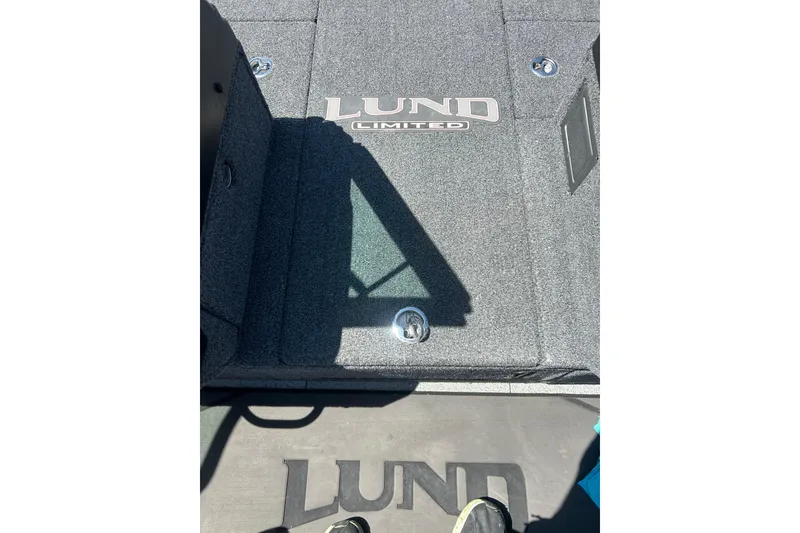 Slide: The Image of 2021 Lund 2075 Pro-V Limited boat deck with logo and carpeted surface. - 23