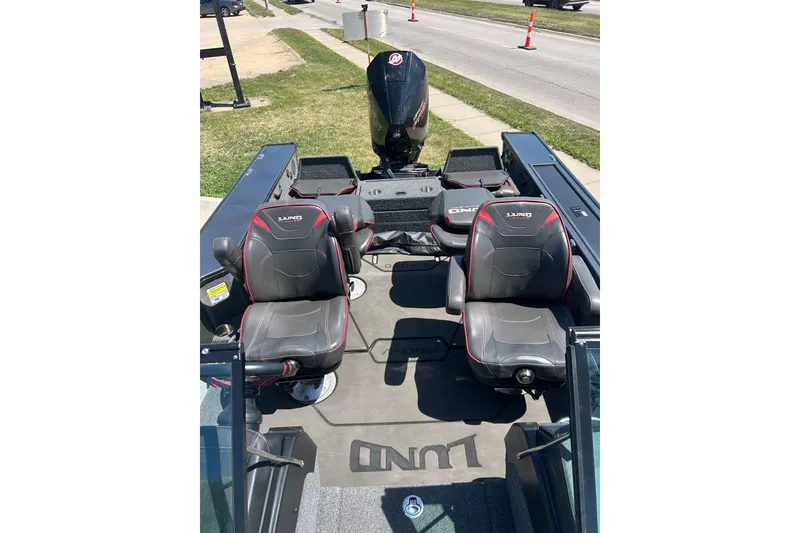 Slide: The Image of 2021 Lund 2075 Pro-V Limited boat interior with two seats and motor. - 27