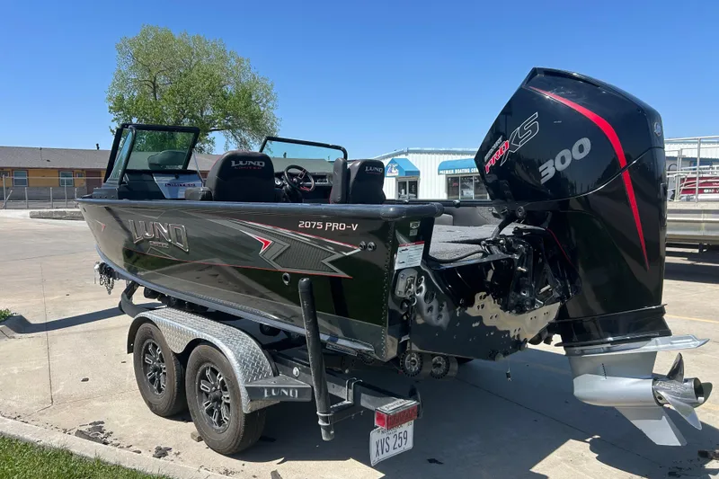 Slide: The Image of 2021 Lund 2075 Pro-V Limited boat with powerful 300 HP engine on trailer. - 5