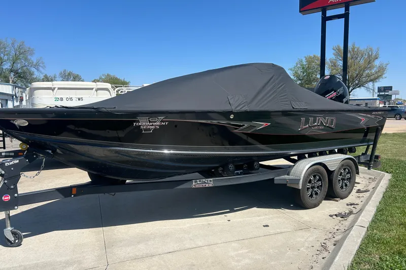 Slide: The Image of 2021 Lund 2075 Pro-V Limited boat with cover on trailer, parked outdoors. - 8
