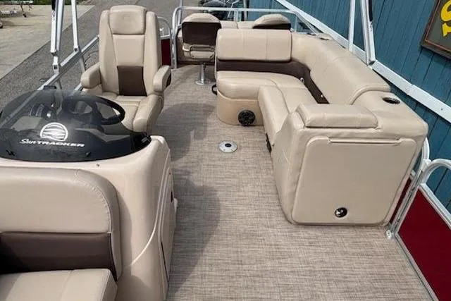 Slide: The Image of 2019 Sun Tracker SportFish 22 DLX pontoon boat with beige seating and spacious deck layout. - 12