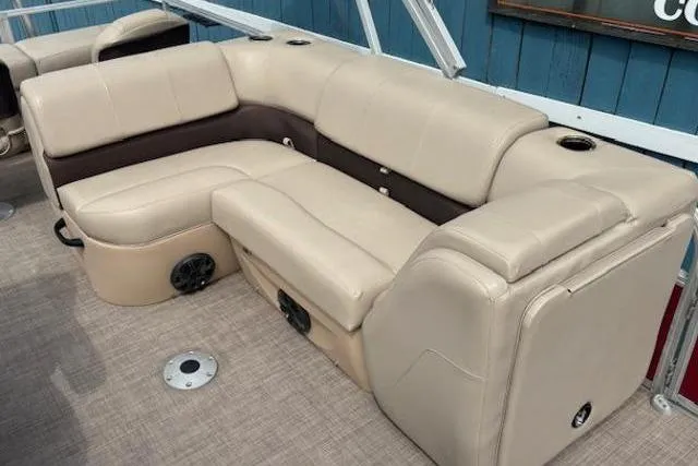 Slide: The Image of 2019 Sun Tracker SportFish 22 DLX pontoon boat with beige seating and cup holders. - 13