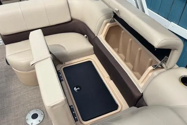 Slide: The Image of 2019 Sun Tracker SportFish 22 DLX boat interior with beige seating and storage compartments. - 14