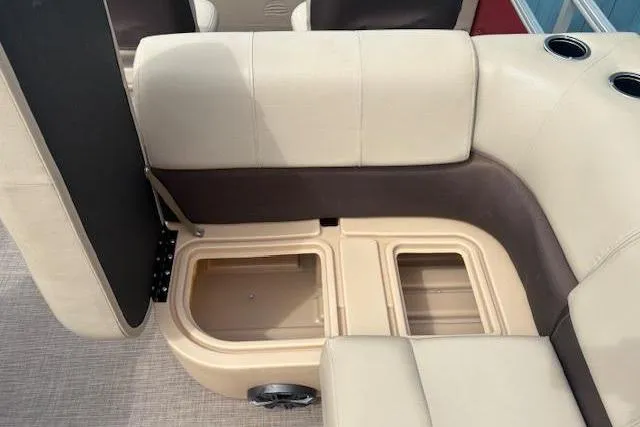 Slide: The Image of 2019 Sun Tracker SportFish 22 DLX boat seating with storage compartments open. - 15