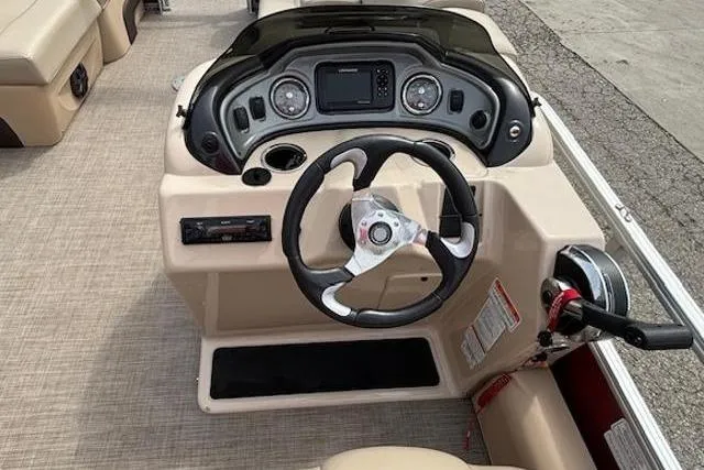 Slide: The Image of 2019 Sun Tracker SportFish 22 DLX boat dashboard with steering wheel and controls. - 18