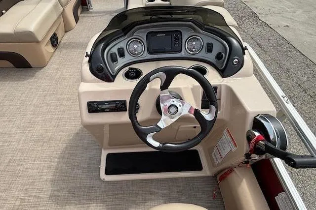 Slide: The Image of 2019 Sun Tracker SportFish 22 DLX boat dashboard with steering wheel and control panel. - 19