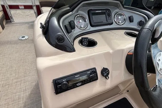 Slide: The Image of 2019 Sun Tracker SportFish 22 DLX dashboard with steering wheel and control panel. - 20