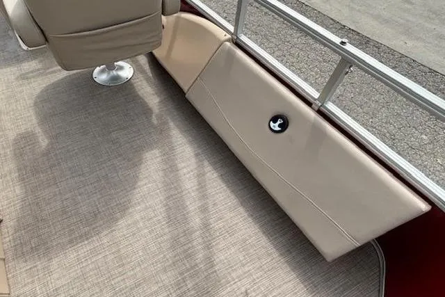 Slide: The Image of 2019 Sun Tracker SportFish 22 DLX interior with beige seating and carpeted flooring. - 21