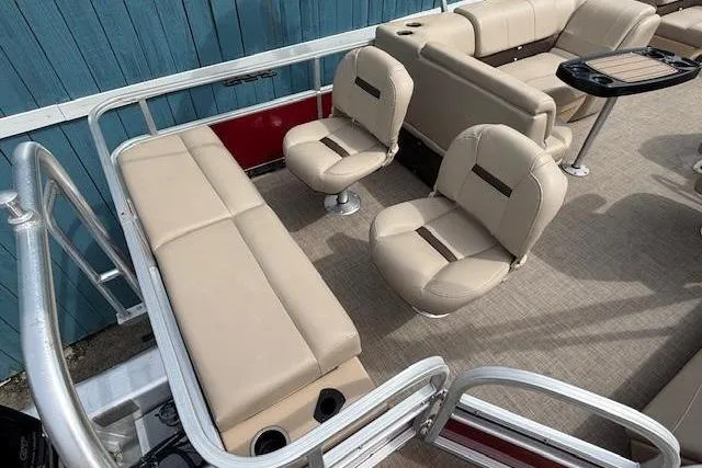 Slide: The Image of 2019 Sun Tracker SportFish 22 DLX pontoon boat interior with beige seating and table. - 23