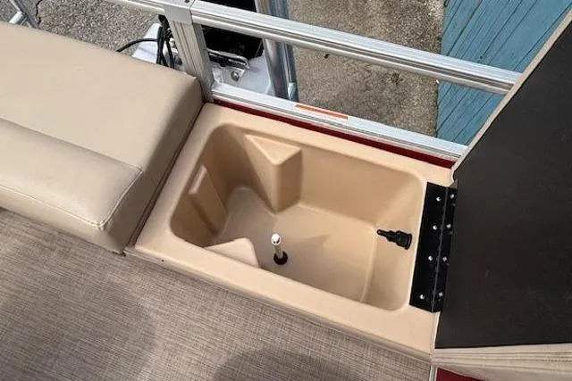 Slide: The Image of 2019 Sun Tracker SportFish 22 DLX boat storage compartment with beige interior. - 24