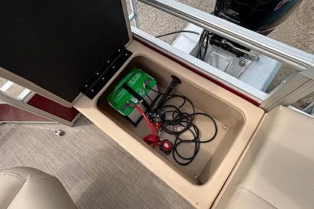 Slide: The Image of 2019 Sun Tracker SportFish 22 DLX boat battery compartment with cables and storage. - 25