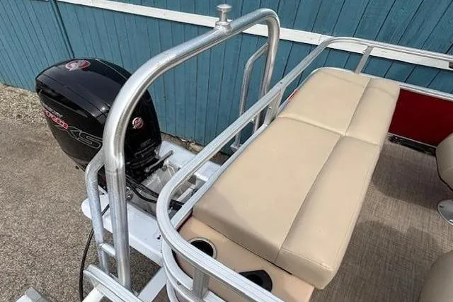 Slide: The Image of 2019 Sun Tracker SportFish 22 DLX boat with beige seating and outboard motor. - 26