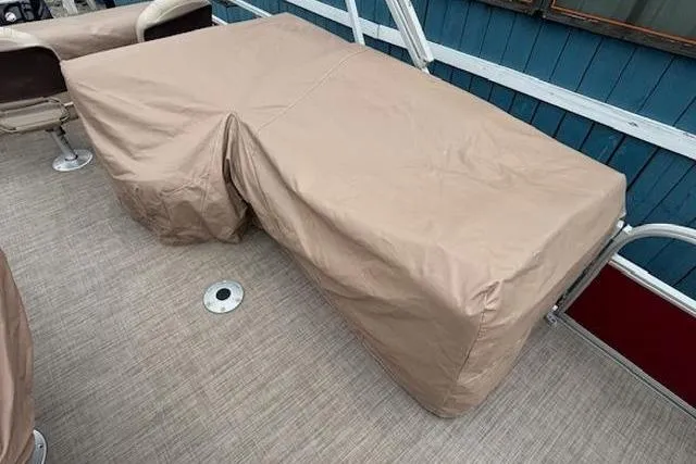 Slide: The Image of 2019 Sun Tracker SportFish 22 DLX boat interior with beige protective covers. - 29