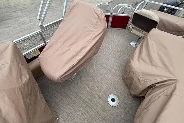 Slide: The Image of 2019 Sun Tracker SportFish 22 DLX boat interior with covered seats and carpeted floor. - 30