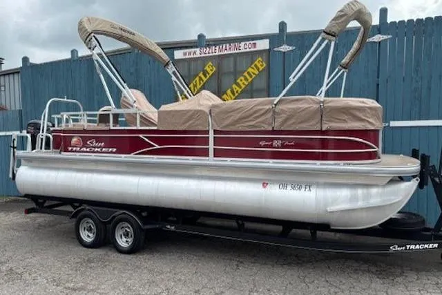 Slide: The Image of 2019 Sun Tracker SportFish 22 DLX pontoon boat on trailer, parked outdoors. - 32