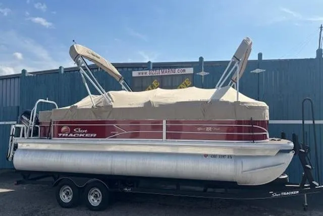Slide: The Image of 2019 Sun Tracker SportFish 22 DLX pontoon boat on trailer, covered and parked outdoors. - 33
