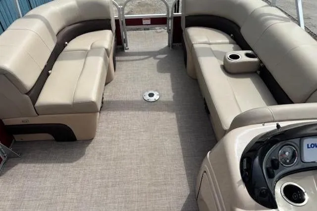 Slide: The Image of 2019 Sun Tracker SportFish 22 DLX pontoon boat interior with beige seating and console. - 8