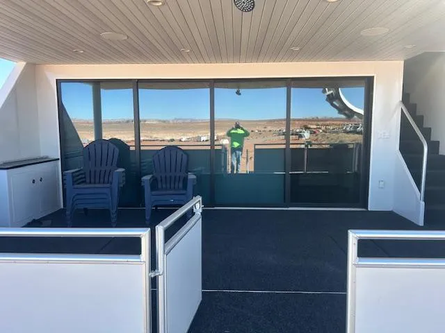Slide: The Image of Outdoor deck of Adonia Ovation Shared Ownership Trip 5, featuring chairs and glass doors, 2023. - 6