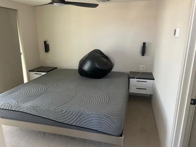 Slide: The Image of Modern bedroom with gray bedspread, bean bag, and minimalist decor in Adonia Ovation 2023 model. - 9